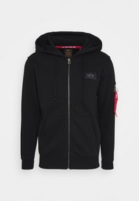 Black zip-up hoodie made of soft fabric, featuring a front pocket, drawstring hood, and a red accent on the left sleeve with a zipper detail.