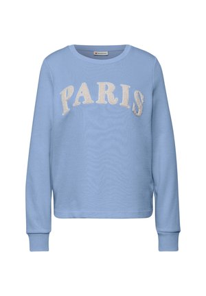 Jasnoniebieska bluza z długimi rękawami, z napisem "PARIS" w kremowym, teksturowanym druku na klatce piersiowej. Prążkowane mankiety i dół.