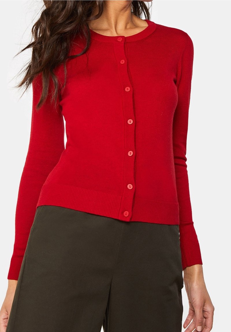 Red fitted cardigan with a round neckline, long sleeves, and button closure; made of soft knit fabric with ribbed cuffs and hem.