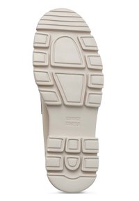 Suela de zapatilla de goma blanca con un patrón texturizado que mezcla formas rectangulares y circulares. Nombre de la marca estampado en el centro.
