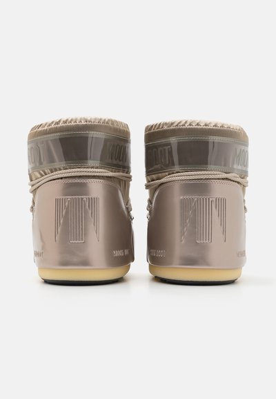 Beige waterproof boots with a shiny finish, featuring a high ankle design, rubber sole, and transparent upper band with branding.