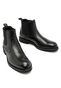 Czarne skórzane botki Chelsea z elastycznymi panelami bocznymi, zaokrąglony nos, gładka tekstura oraz solidna gumowa podeszwa.