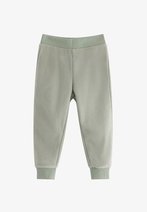 Vaatteet fleece-housut vaaleanvihreänä, joissa on ribattu vyötärö ja käännetyt nilkat. Pehmeä tekstuuri, jossa on sileä pinta ja yksinkertainen muotoilu.