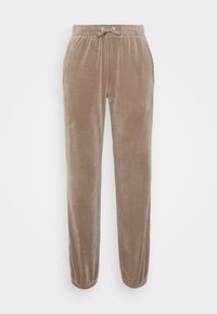 Lichtbruine sweatpants van zachte fluweel, met een elastische tailleband met trekkoord, zijzakken en taps toelopende boorden.