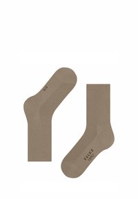 Chaussettes en coton beige de type crew avec texture côtelée, design sans couture au niveau des orteils et branding discret. Fabriquées en mélange de coton doux pour le confort.