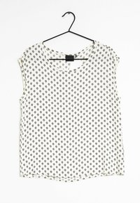 Camicia a maniche corte con scollatura tonda, realizzata in tessuto leggero, con sfondo bianco e piccoli motivi geometrici neri.