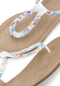 Brown faux leather sandals with woven multicolor straps. The braided design features pastel hues, complemented by a smooth sole.