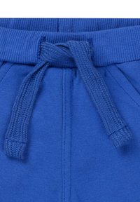 Niebieskie bawełniane dresy z elastycznym pasem, wyposażone w tkany sznurek do regulacji. Materiał jest gładki z matowym wykończeniem i posiada boczne kieszenie.