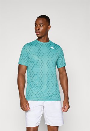 Teal athletic t-shirt with a diamond pattern, short sleeves, and crew neck. Features a white logo on the upper left chest area.