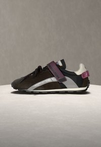 Baskets marron et noires avec bande latérale argentée, bride velcro violette marquée "Dsquared2,", col de talon blanc et semelle noire texturée.