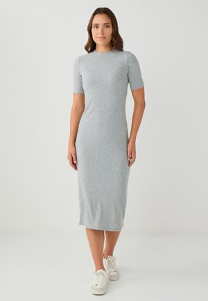 Robe midi grise à côtes avec manches courtes, design ajusté, col rond et texture douce, associée à des baskets blanches.