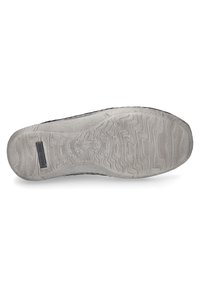 Shoe sole with textured gray rubber, featuring wavy patterns and a branded tag. The edge is slightly raised and smooth.