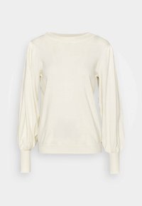 Pull à manches longues couleur crème avec des manches bouffantes et des poignets ajustés, col rond, présenté sur un fond clair uni.