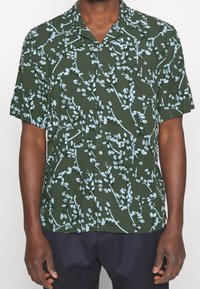 Camicia verde a maniche corte con un motivo floreale in azzurro chiaro, con una vestibilità comoda e colletto button-down.
