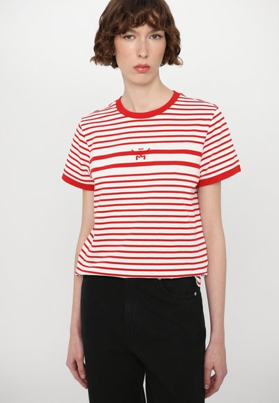 Red and white striped cotton t-shirt with short sleeves, round neckline, and small embroidered logo on the chest. Black pants visible below.