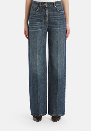 Brede denim jeans in donkerblauw met een gestructureerde afwerking. Voorzien van voortassen, knoopsluiting en een licht uitgefranste zoom.