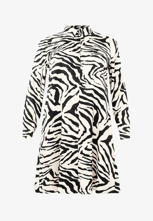 Knoop-jurk met een zwart-wit zebra strepenpatroon, lange mouwen, een kraag en een licht uitlopend silhouet. Gemaakt van een soepele stof.