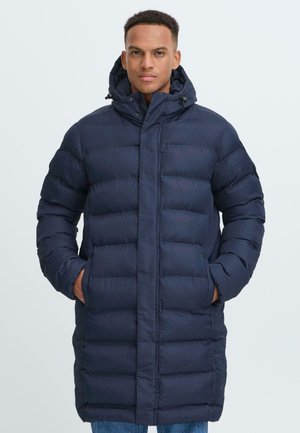 Navy-blue padded coat with a hood, featuring a straight cut, quilted pattern, and two side pockets for storage.