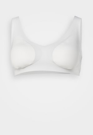 White seamless bra with molded cups, wide straps, and a smooth, stretchy texture designed for comfort and support.