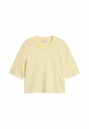 Vaaleankeltainen, lyhythihainen, lyhyt T-paita pyöreällä pääntiellä, väljä istuvuus ja yksivärinen.