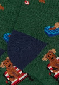 Calze verdi lavorate a maglia con motivi colorati di cani e cibo, con tallone e punta blu scuro.