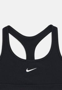 Musta spordibrasi racerback disainiga, valmistatud siledast materjalist, mille esiküljel on valge Nike logo ja mugavuse tagamiseks tasased õmblused.