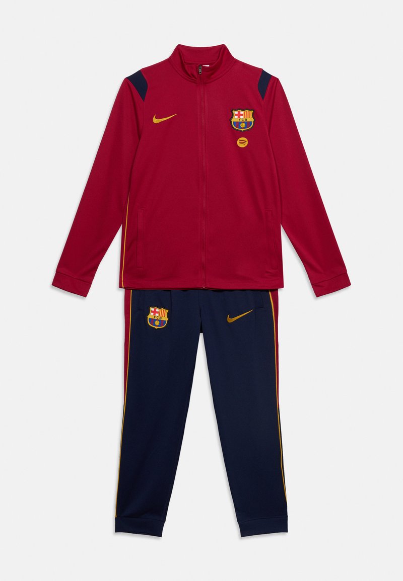 Κόκκινο και ναυτικό μπλε φόρμα FC Barcelona με μπουφάν και παντελόνι με φερμουάρ, με λογότυπα Nike και ομάδα, καθώς και κίτρινες πλαϊνές ρίγες.