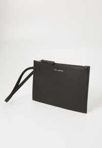 Black leather clutch with a zip closure, rectangular shape, detachable wrist strap, and embossed brand logo on the front. Smooth texture.