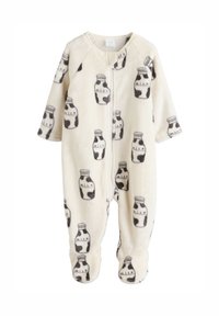 Combinaison bébé en polaire crème avec imprimé bouteilles de lait grises, manches longues, fermeture éclair et pieds intégrés pour plus de chaleur. Texture douce.