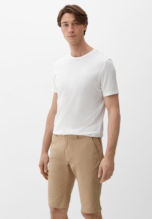 White short-sleeve T-shirt paired with tan knee-length shorts. Soft cotton fabric, simple design, and clean lines. No patterns or accents.