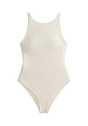 Jednodielne plavky v svetlo krémovej farbe, s textúrou vyvýšeného vzoru, vybavené širokými ramienkami a zaobleným výstrihom. Klasický, priliehavý strih.