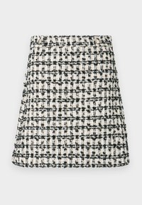 Vævet nederdel i beige og sort tweedmønster. Lige pasform med let skørt ved kanten. Har en linning med en knappedetalje.