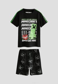 Sort T-shirt med korte ærmer og grønne detaljer, med et Minecraft-motiv. Sorte shorts med gentagende Creeper-ansigtsmønster. Materiale i bomuldsblanding.