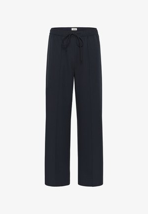 Pantalones de pierna ancha negros con cinturilla elástica y cordón, y detalles de costura frontal, etiquetados "soaked" en la parte trasera de la cintura.