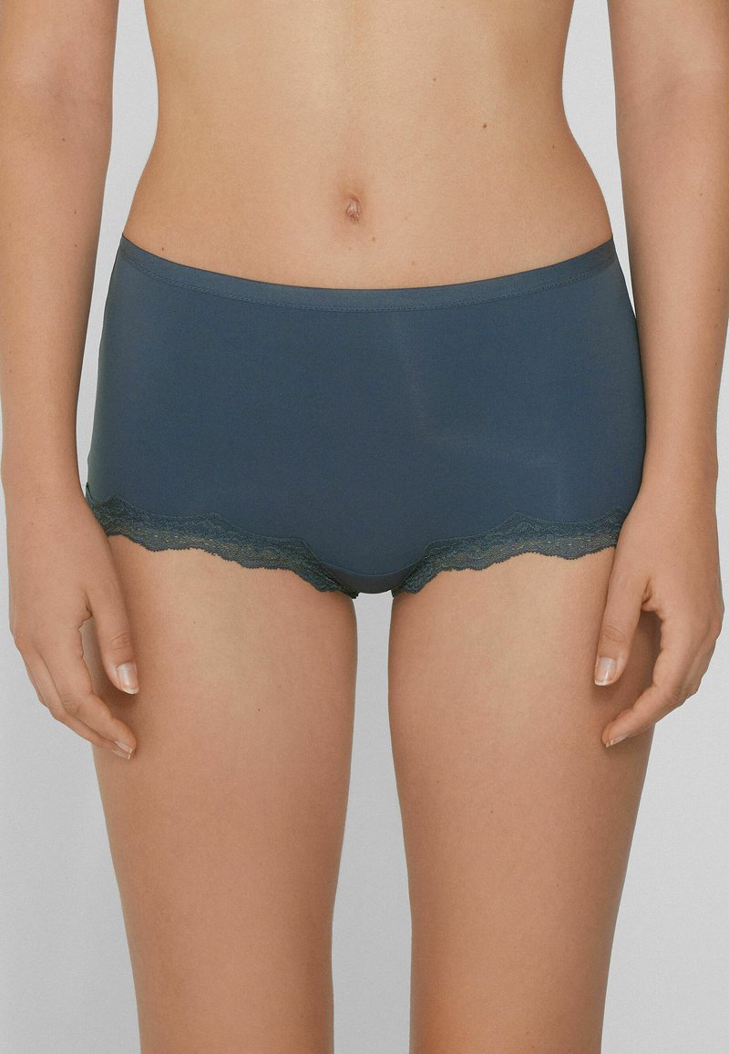Calzoncillos hipster azul oscuro de tela suave, con un borde de encaje en las aberturas de las piernas para un detalle adicional.