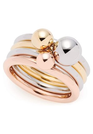 Nałożone na siebie błyszczące metalowe pierścionki w kolorze różowego złota, złota i srebra, każdy z gładką, refleksyjną kulistą koraliką na wierzchu.