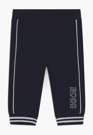 Pantalones azul marino para toddlers con rayas blancas laterales, puños acanalados con rayas blancas y el logo "BOSS HUGO BOSS" en la pierna izquierda.