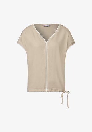 Beige top met korte mouwen en V-hals, witte rand langs de randen en een verstelbare strik aan de zijkant voor een aanpasbare pasvorm. Gladde stoftextuur.