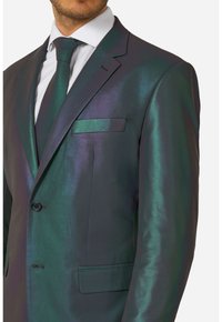 Donkergroene en paarse iriserende pak met glanzende textuur, enkele knoopsluiting, notch-revers en een bijpassende stropdas. Inclusief pochet.