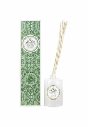 Valkoinen lasinen diffuusori, jossa on pullot, pakattuna vihreään koristeelliseen laatikkoon, jossa on monimutkaisia kuvioita. Etiketissä lukee "VOLUSPA Marokkolainen Minttutee."