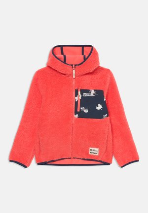 Red fleece jacket with a hood, featuring a navy blue pocket adorned with a Moomin pattern and a brand logo. Zipper closure and soft texture.