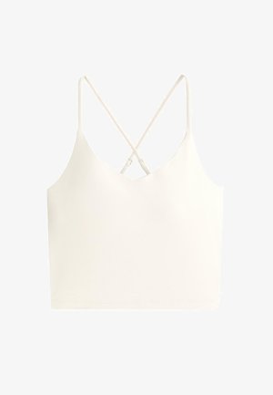 Top scurt crem cu bretele subțiri încrucișate, reglabile și decolteu în V.