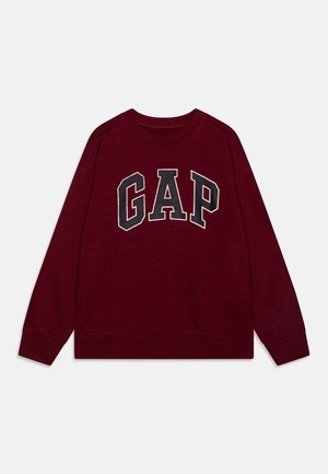 Bordeaux langærmet sweatshirt med rund hals og stort sort-hvidt "GAP"-logo centreret på brystet.