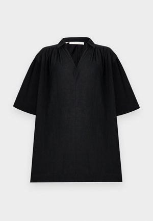 Musta löysä mekko, jossa V-kaula-aukko, kerätyt olkapäät, leveät kyynärtaipeen mittaiset hihat ja pieni kaulus.