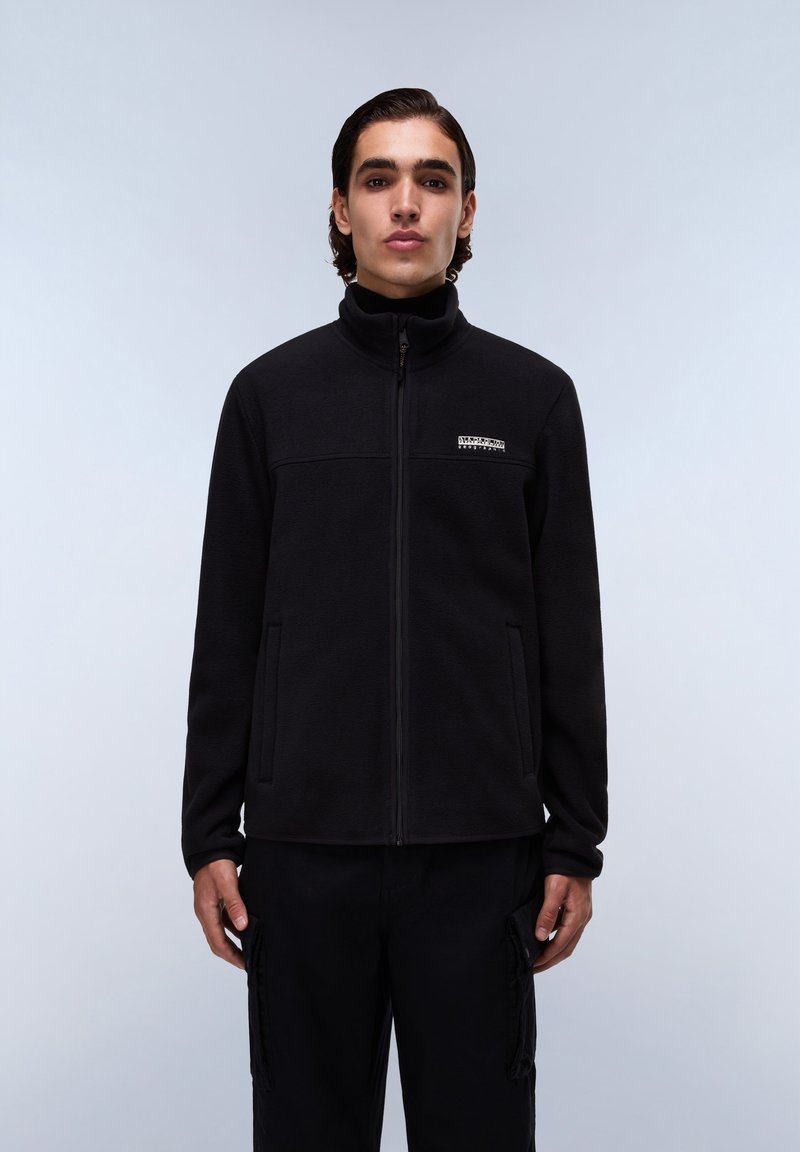 Black fleece jacket with high collar, front zipper, and two side pockets. Features a small logo patch on the chest area.