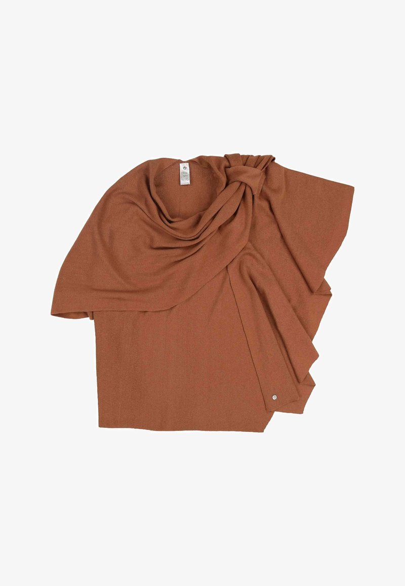 Poncho en tricot marron avec devant drapé et détail noué près de l'encolure, posé à plat sur un fond blanc.
