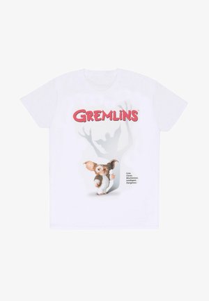Witte katoenen t-shirt met een grafiek van een gremlin-personage met prominente oren, tekst en een schaduw-silhouet effect erachter.