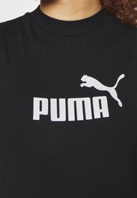 Black cotton t-shirt with a round neckline, featuring a large white "PUMA" logo and a leaping cat graphic in white.