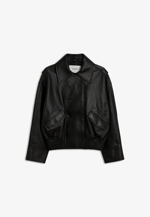 Black faux leather jacket with large collar, snap buttons, two angled front pockets, elastic waistband, and long sleeves on a white background.