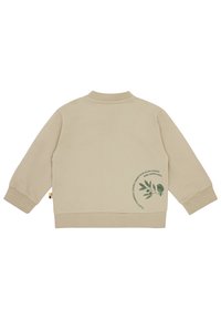 Beige Sweatshirt mit einem runden Logo, das einen grünen Vogel und Blätter auf dem Rücken zeigt. Gerippter Kragen und Bündchen, weiche Textur und elastischer Saum.
